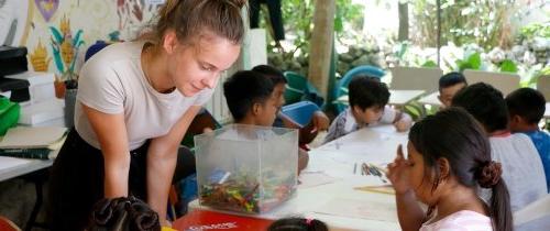 Student intern teaching children while studying abroad